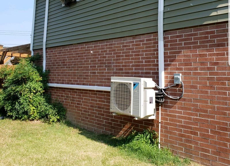 Ductless Mini-Split Heat Pump outside of brick house